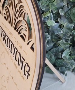 Botanical arch detail on personalised wooden wedding welcome sign