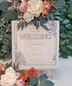 Personalised Botanical Frame Wedding Welcome Sign in square format, layered wooden design with floral corner details, custom names and wedding date, displayed on wooden stand