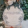 Personalised Floral Wreath Wedding Welcome Sign in circular wooden design with layered floral border and custom names and wedding date