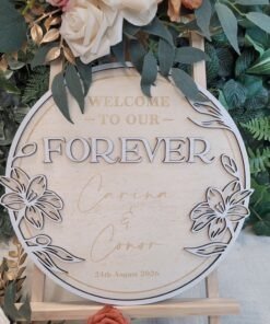 Personalised Floral Wreath Wedding Welcome Sign in circular wooden design with layered floral border and custom names and wedding date