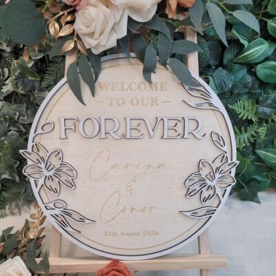Personalised Floral Wreath Wedding Welcome Sign in circular wooden design with layered floral border and custom names and wedding date