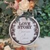 Personalised Floral Wreath Wedding Welcome Sign in circular wooden design with layered floral border and custom names and wedding date