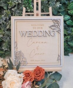 Personalised Botanical Frame Wedding Welcome Sign in square format, layered wooden design with floral corner details, custom names and wedding date, displayed on wooden stand